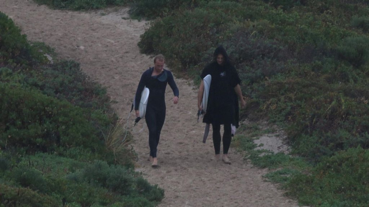 Nat Fyfe (right) was photographed after surfing in Margaret River, WA. The state is currently under a tight lockdown.