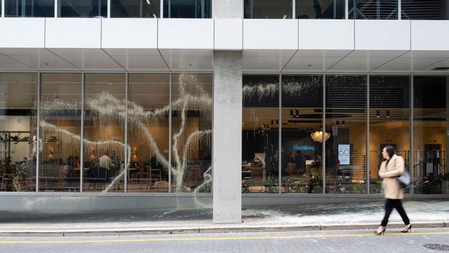 Paint smeared across Bluprint cafe at the bottom of the Santos building on Flinders Street. Picture: NCA NewsWire / Morgan Sette