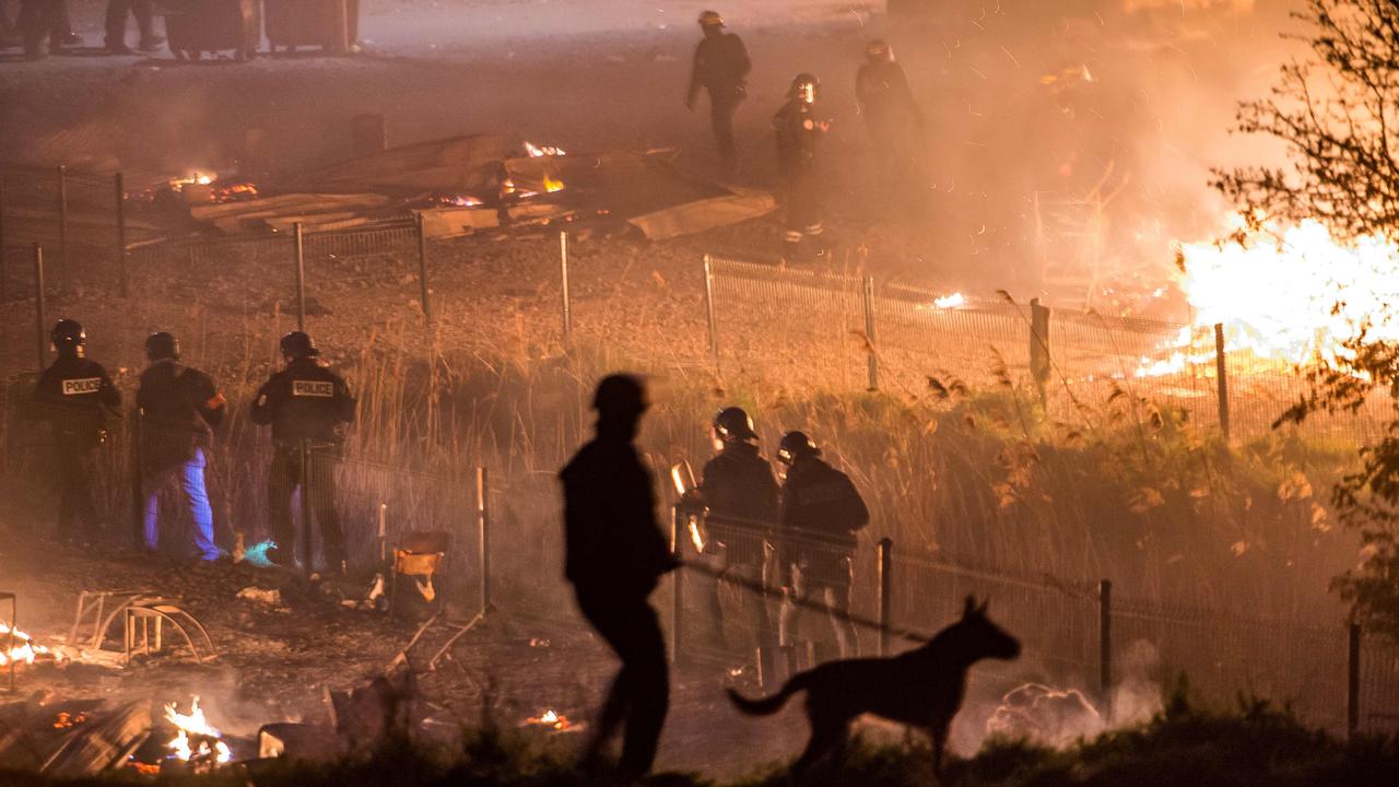 French police patrol migrant camp outside Dunkirk. Picture: Philippe Huguen/AFP