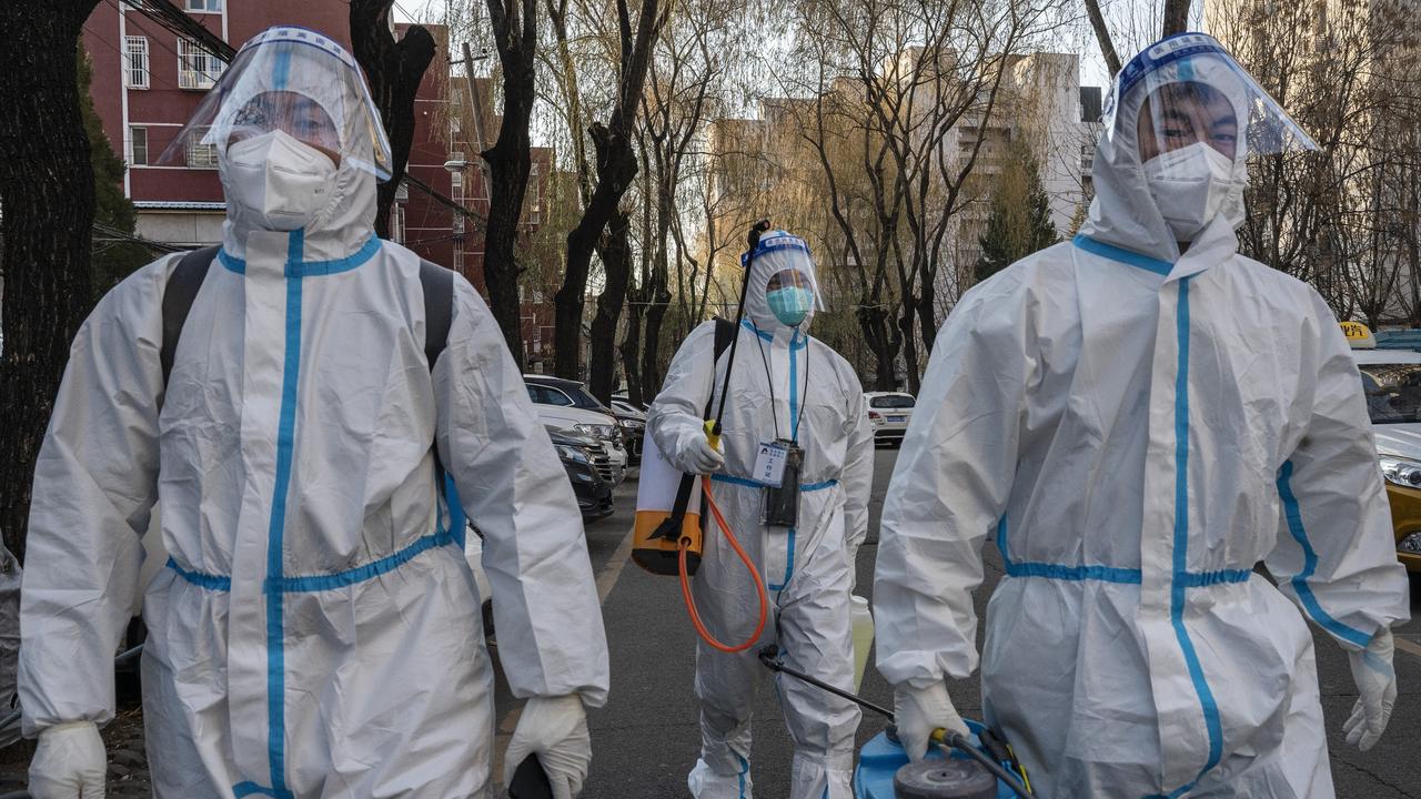 Epidemic control workers, dubbed China’s ‘Big Whites’. Picture: Kevin Frayer/Getty Images