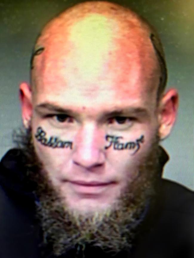 Arron Mathew Simmons with his misspelled face tattoo.