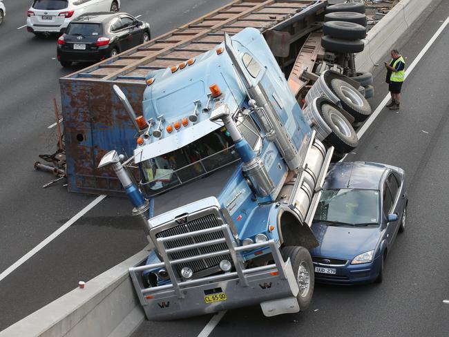 The truck hit a concrete barrier and came to rest on top of a car. Picture: David Crosling.