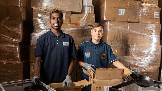 Clontarf Academy students Alonzo Nelson, 15, from Yirara College and Isaiah Miller,13, from Centralian Middle School at their part time job at KMart where they decant products to be put on the shelf. Photo: EMMA MURRAY