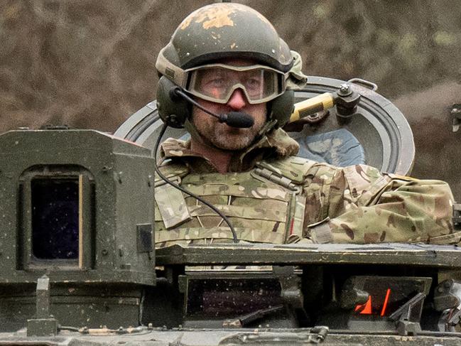 Britain's Prince William, Prince of Wales rides in a Challenger 2 tank while visiting British service personell at the Tapa Army Base, northern Estonia on March 21, 2025. Prince of Wales joines soldiers from the UK and Estonia at Tapa, home to Britain's largest overseas military deployment, some 140km west of the Russian border. (Photo by RAIGO PAJULA / AFP)