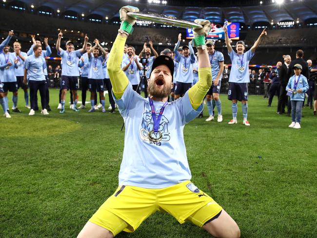 PERTH, AUSTRALIA - MAY 19: Andrew Redmayne of Sydney FC celebrates with the trophy after winning the 2019 A-League Grand Final match between the Perth Glory and Sydney FC at Optus Stadium on May 19, 2019 in Perth, Australia. (Photo by Cameron Spencer/Getty Images)