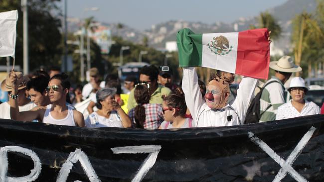 People take part in a march for peace and against violence in Acapulco in April. Picture: Pedro Pardo/AFP