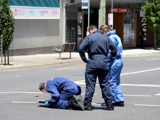 Police at the scene of the shooting on Monday. Picture: Andrew Henshaw