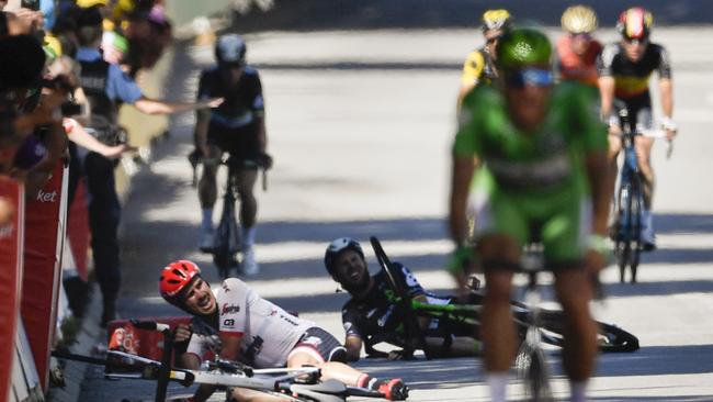 Germany's John Degenkolb (L) and Great Britain's Mark Cavendish (2ndL) lie stranded after crashing during the concluding stages of the Tour de France stage four.