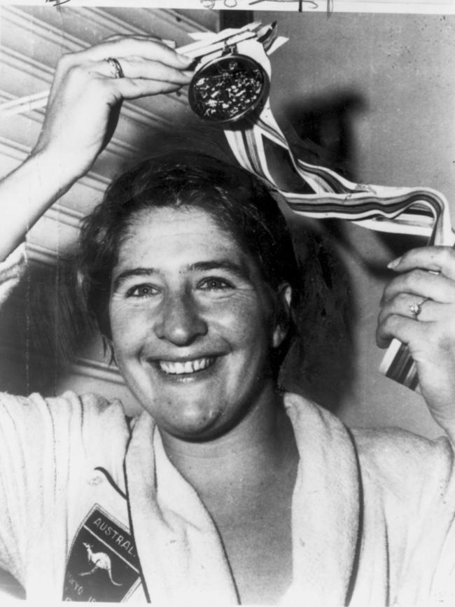 Swimmer Dawn Fraser shows off her Olympic gold medal that she received for winning the 100m freestyle at the 1964 Tokyo Olympics.