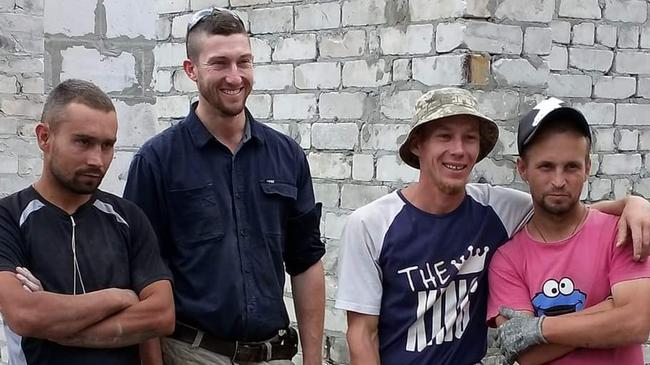 Geeveston carpenter Hamish Stirling (second from left) with locals in Ukraine. Picture: Supplied