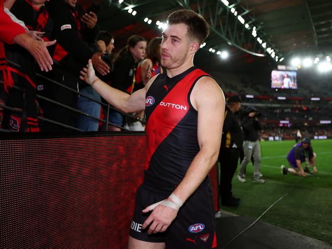 MELBOURNE, AUSTRALIA - MAY 10: Zach Merrett of the Bombers greets fans following the round nine AFL match between Essendon Bombers and Sydney Swans at Marvel Stadium, on May 10, 2025, in Melbourne, Australia. (Photo by Morgan Hancock/Getty Images)
