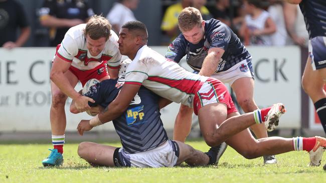 Newcastle’s Matt Soper-Lawler tackled by Monaro. Picture: Sue Graham