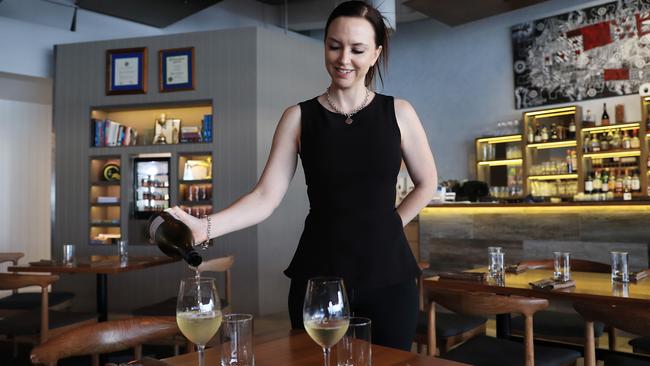 Ochre restaurant general manager and director Carley Elsum pouring wine to pair with a range of delicious menu items on offer. Picture: Brendan Radke