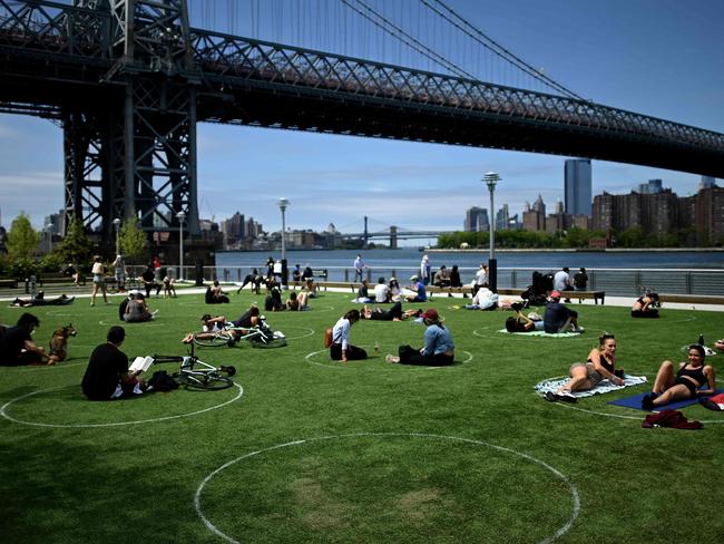 People are seen practising social distancing in white circles in Domino Park in Brooklyn. Picture: AFP