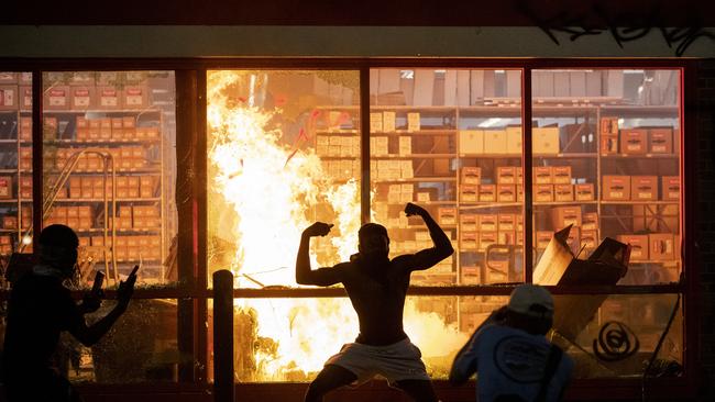 An AutoZone store is set alight during a rally for George Floyd in Minneapolis on Wednesday. Picture: AP