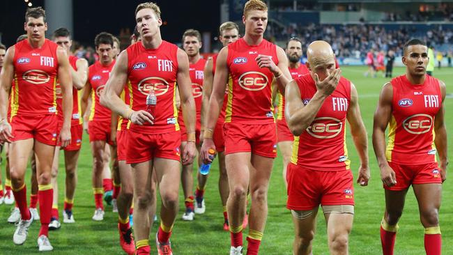 Gary Ablett leads the Suns off Simonds Stadium after heavy loss to Geelong. Picture: Getty