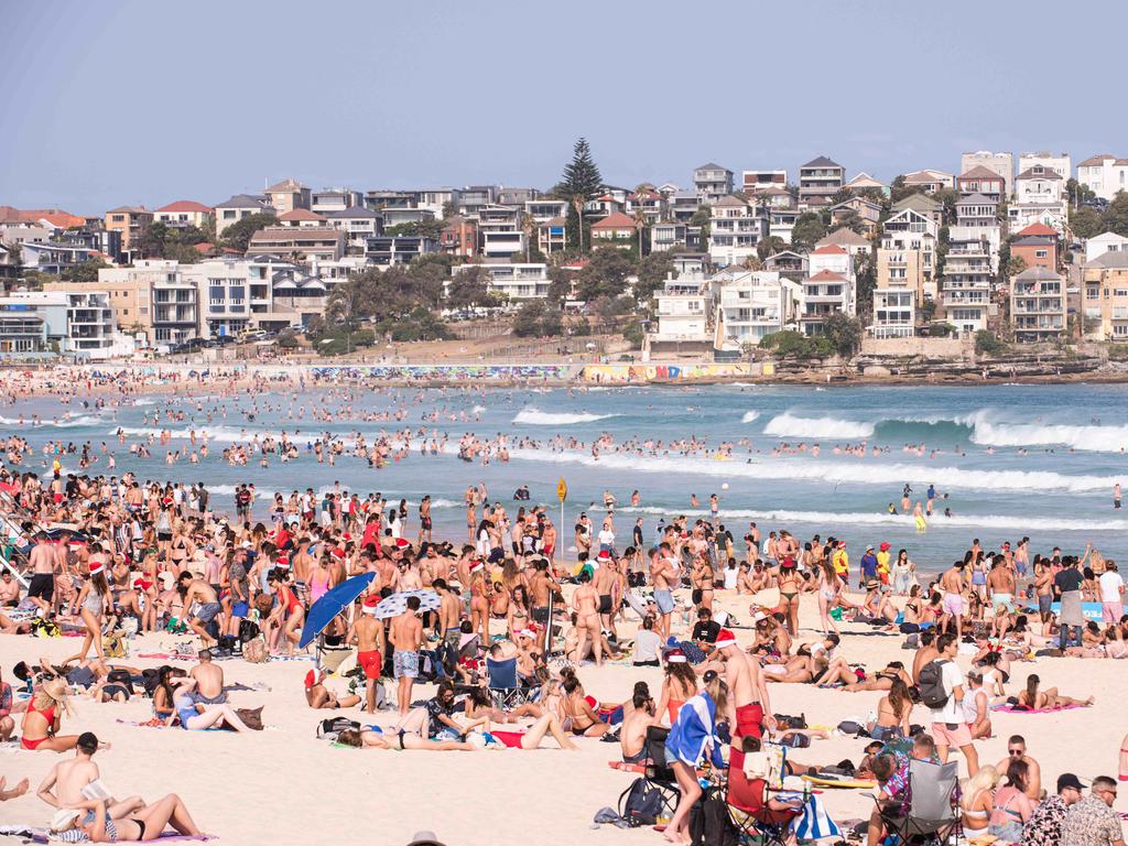 Thousands flock to Bondi Beach on Christmas Day in 2019. This year, the tourists will be largely absent. Picture: Daily Telegraph/Flavio Brancaleone