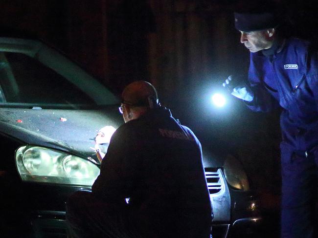 DANDENONG, VICTORIA - JUNE 07: Forensic officers examine flecks of red debris on the hood of a car on Princes Hwy. Gwenda Street on June 07, 2018 in Dandenong, Victoria. (Photo by Patrick Herve) Fees Exist)