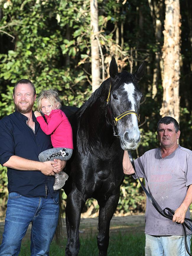 Racehorse owner Chris Jorgensen and his daughter Athena with his horse Taveuni and Cairns Trainer Rodney Miller. PICTURE: STEWART MCLEAN