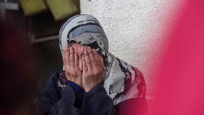 People mourn as they receive the bodies of victims of an Israeli strike in Rafah.