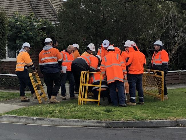 An army of NBN workers gather around a hole in Spotswood.