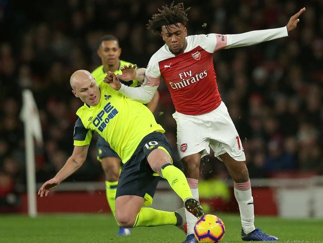 Arsenal's Nigerian striker Alex Iwobi (R) vies with Huddersfield Town's Australian midfielder Aaron Mooy (L) during the English Premier League football match between Arsenal and Huddersfield Town at the Emirates Stadium in London on December 8, 2018. (Photo by Daniel LEAL-OLIVAS / AFP) / RESTRICTED TO EDITORIAL USE. No use with unauthorized audio, video, data, fixture lists, club/league logos or 'live' services. Online in-match use limited to 120 images. An additional 40 images may be used in extra time. No video emulation. Social media in-match use limited to 120 images. An additional 40 images may be used in extra time. No use in betting publications, games or single club/league/player publications. /