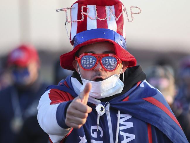 GRAND RAPIDS, MI - NOVEMBER 02: A supporter arrives for an election eve rally for President Donald Trump on November 2, 2020 in Grand Rapids, Michigan. Trump and Democratic presidential nominee Joe Biden are making last-minute stops in swing states ahead of tomorrow's general election.   Kamil Krzaczynski/Getty Images/AFP == FOR NEWSPAPERS, INTERNET, TELCOS & TELEVISION USE ONLY ==