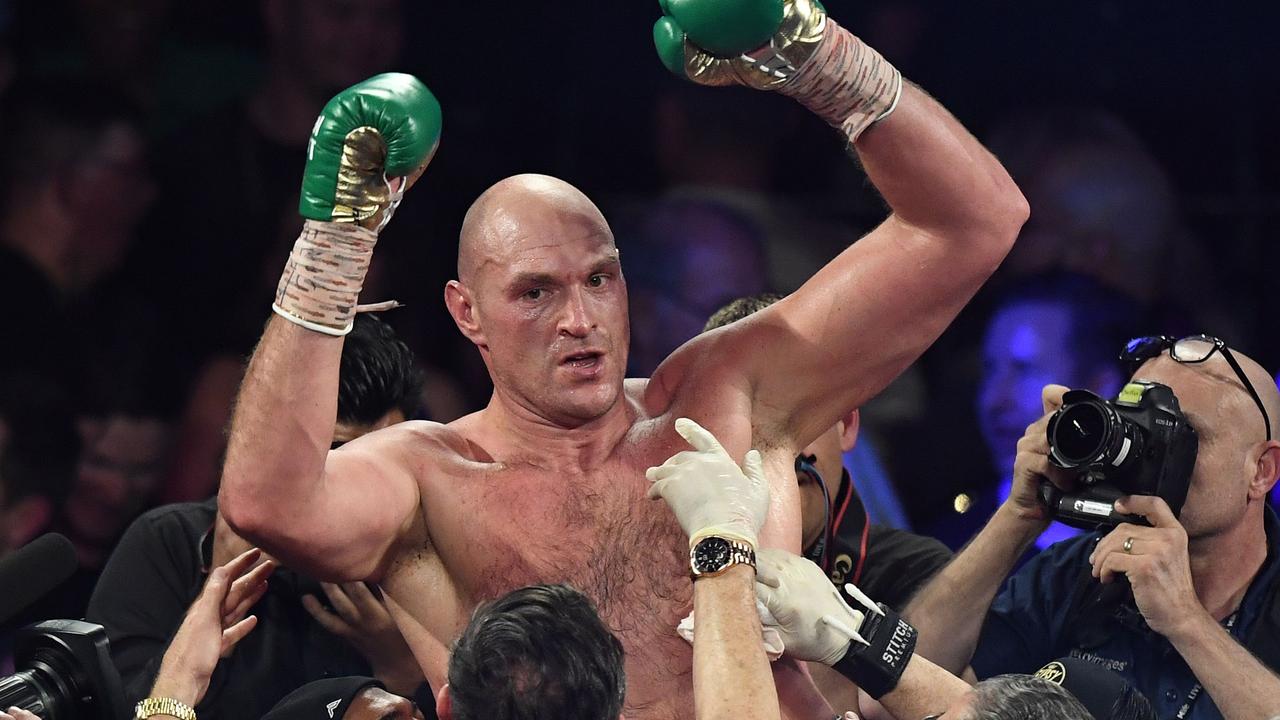 British boxer Tyson Fury celebrates his return to the throne.