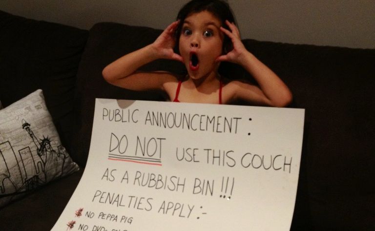 Six-year-old Indigo had an announcement board created by her mother to get the message across that if she dumps her rubbish in or behind the couch again, she faced harsh punishments. Picture: Contributed