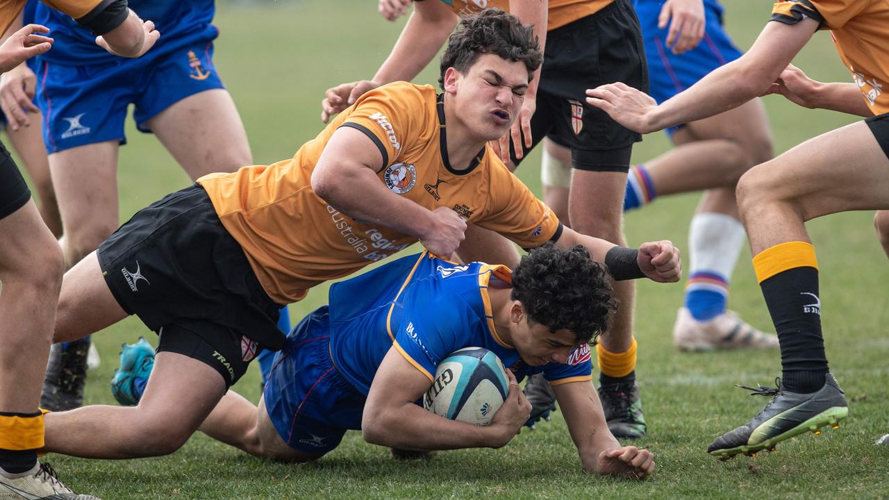 Talen Risati is tackled in City v Country. Picture: Julian Andrews