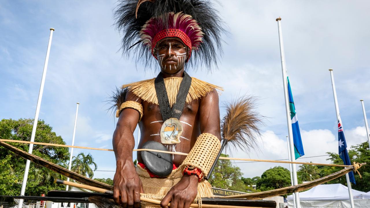 An Australian Army soldier from Sarpeye (Charlie) Company, 51 FNQR dressed in traditional Torres Strait Islander clothing mounts the Cenotaph during the Torres Strait Island Light Infantry Battalion 80th anniversary ceremony held at Thursday Island. Picture: Supplied.