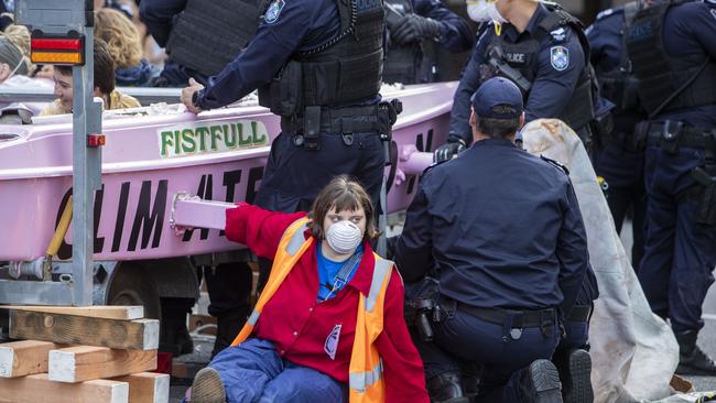 Activists from Extinction Rebellion are seen attached to a catamaran in the middle of the Brisbane CBD this week. Picture: AAP