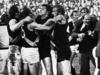 18/05/1974. Players, coaches, fans and officials get involved in the infamous 1974 Richmond and Essendon fracas at Windy Hill. Brawl. Football. Richmond team manager Graeme Richmond is pulled from the scuffle. Battle of Windy Hill. Richmond v Essendon. 1974. Richmond team manager Graeme Richmond (middle, in suit and tie) is pulled away. Tiger Wayne Walsh is pictured behind Richmond's right shoulder, teammate Bryan Wood is far left, while Bomber Laurie Moloney (wearing No. 34) is far right. Identifiable players in the scuffle are, from left, Ian Stewart, Paul Sproule (wearing No. 6) and Ken Fletcher.
Neg: GE18284