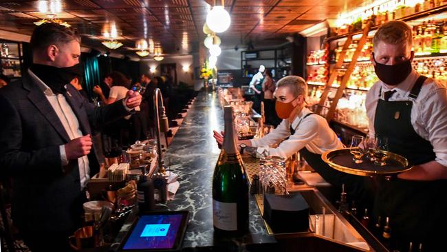 Patrons enjoy a drink in Nick &amp; Nora's bar at a midnight opening in Melbourne last night Picture: AFP