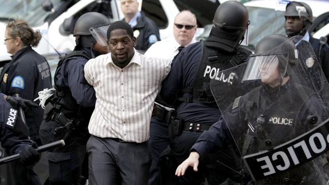 Police arrest a protest organiser following the game between the St. Louis Rams and the Oakland Raiders.