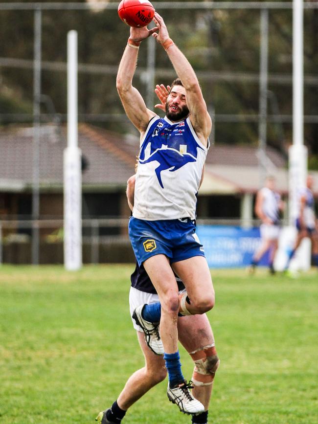 Sunbury Kangaroos forward Josh Burgess flies for an overhead mark. Picture: Aaron Cook.