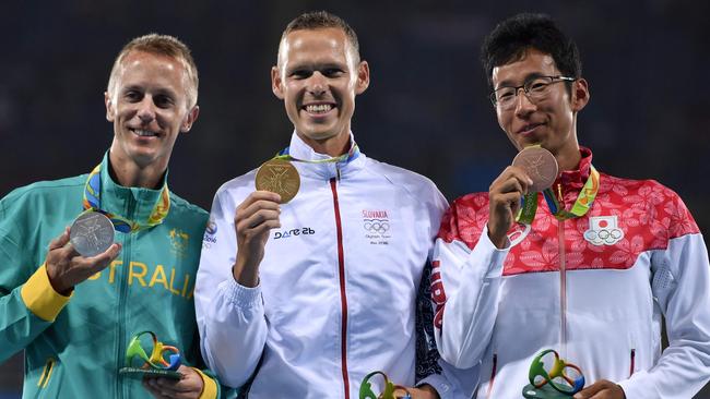 Australia's Jared Tallent (left) on the podium with his silver medal for the 50km race walk with winner   Matej Toth of Slovakia (centre) and bronze medal winner Hirooki Arai of Japan.