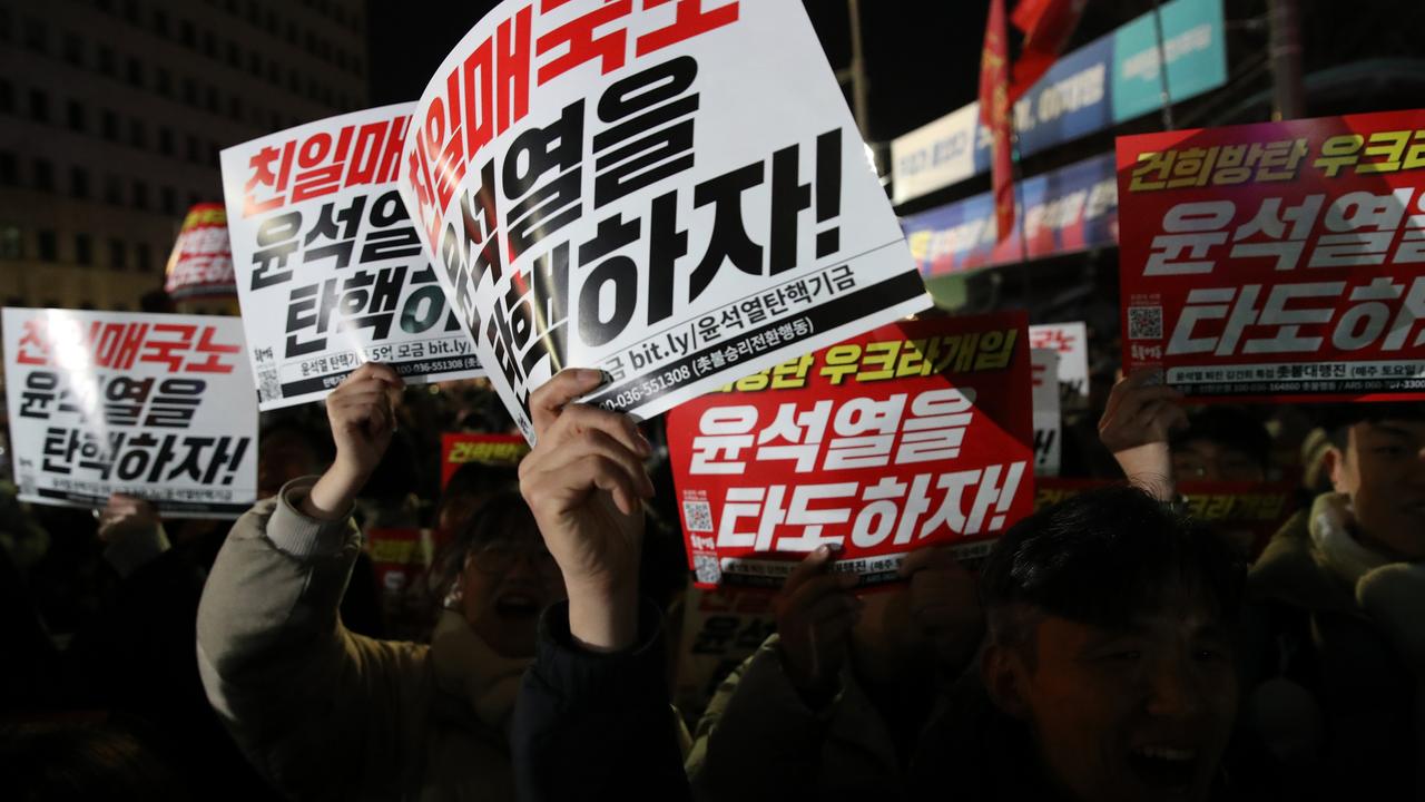 People gather in front of the National Assembly protesting against the decree. Picture: Chung Sung-Jun/Getty Images