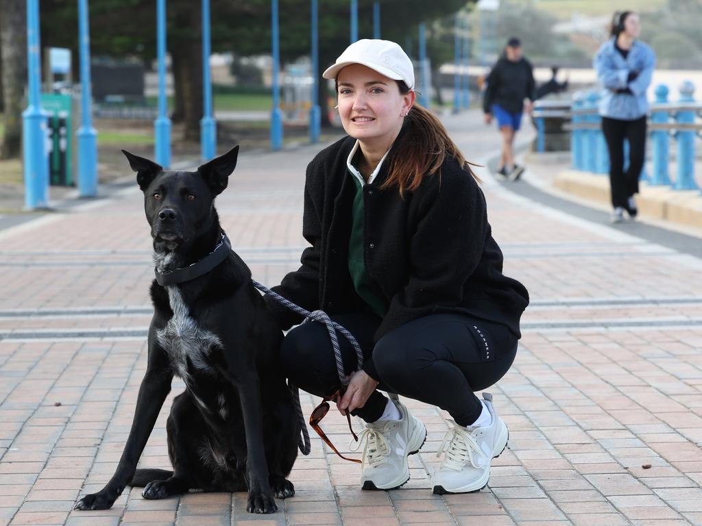 Anna Syder, with her dog Luigi at Coogee Beach, says budgeting has been difficult under high inflation and rising interest rates. Picture: Rohan Kelly