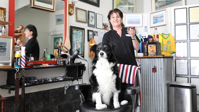 Eliza MacAskill, daughter of the late Jim (James) MacAskill, barber in New Town, with Daisy the Border Collie, celebrating the life of her father with a wee dram. Picture : Mireille Merlet