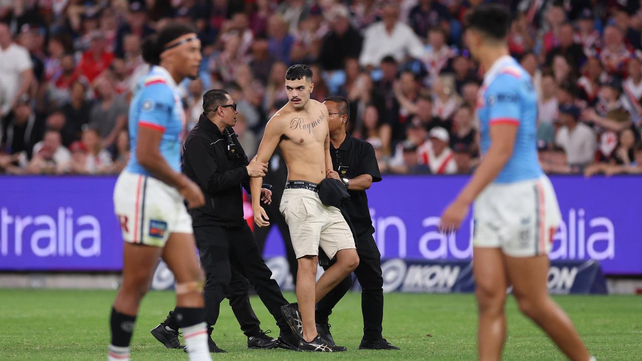 Pitch invader managed to hug Dragons centre Zac Lomax. (Photo by Mark Kolbe/Getty Images)