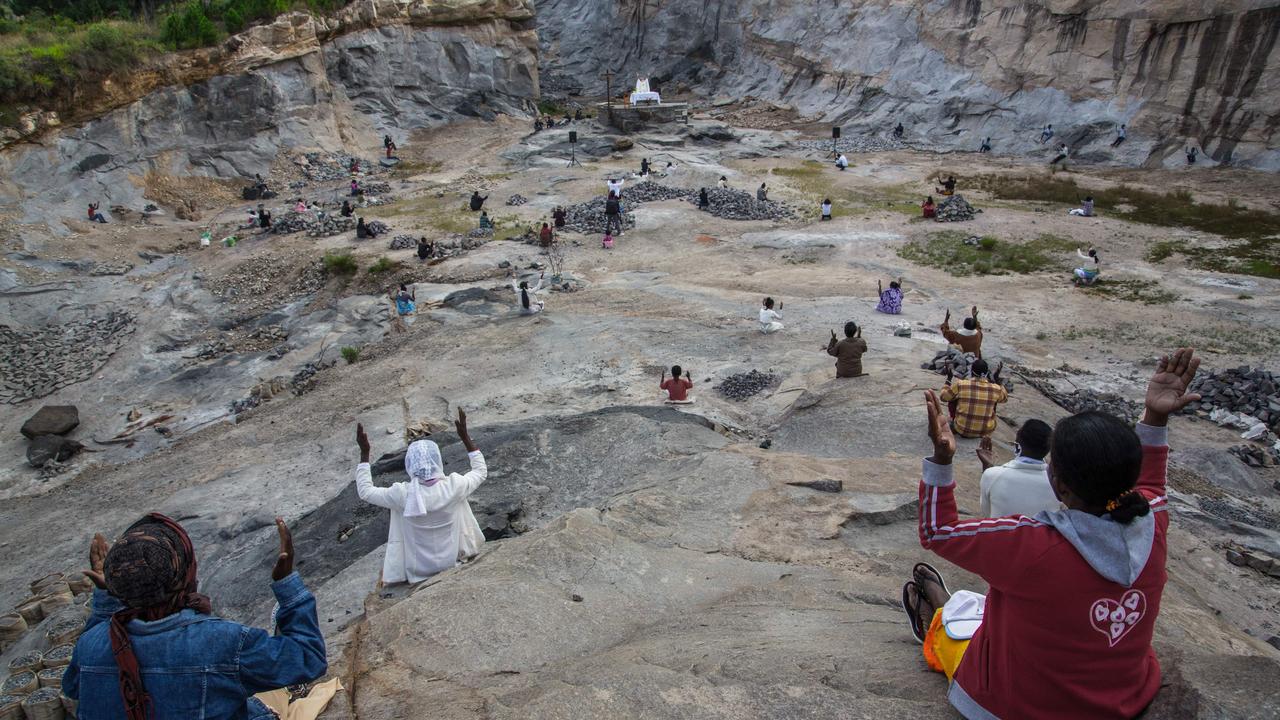 Father Pedro, founder of the Akamasoa association, conducts the traditional great mass celebrating Easter in a granite quarry in Antananarivo, Madagascar following social distancing practices. Picture: AFP