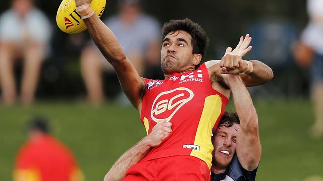 Jack Martin is put under pressure by Geelong defender Jed Bews. Picture: AAP