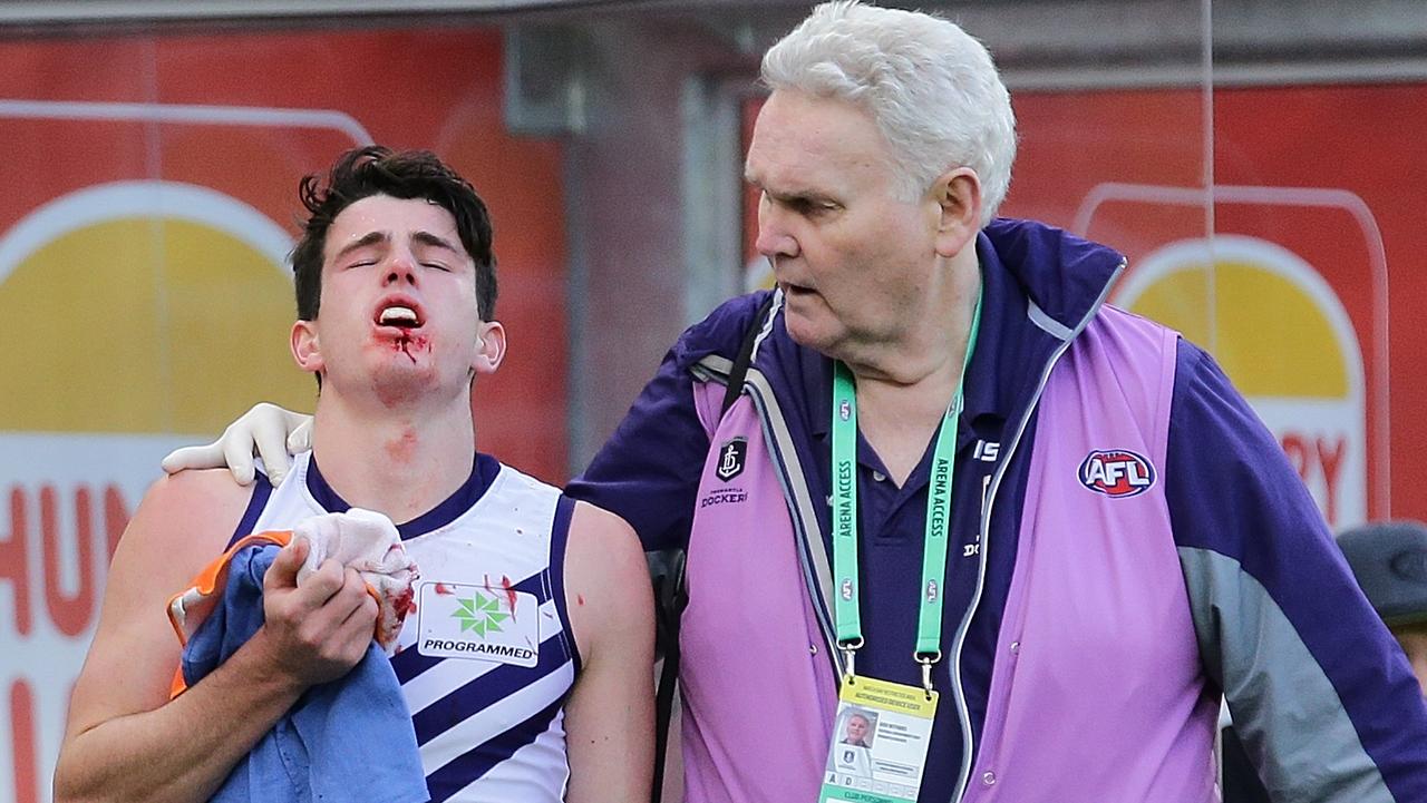 PERTH, WESTERN AUSTRALIA — AUGUST 05: Andrew Brayshaw of the Dockers leaves the field with a suspected broken jaw from contact with Andrew Gaff of the Eagles during the round 20 AFL match between the West Coast Eagles and the Fremantle Dockers at Optus Stadium on August 5, 2018 in Perth, Australia. (Photo by Will Russell/AFL Media/Getty Images)