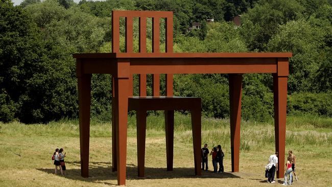 London residents inspect the giant sculpture of a table and chair called The Writer by artist Giancarlo Neri on Hampstead Heath. Picture: Getty