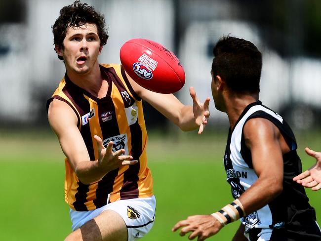 Big River Hawks' Joel Buderick takes a pass as Palmerston Magpies defender closes in during Saturday's U-18 game at Marrara.Picture: Justin Kennedy