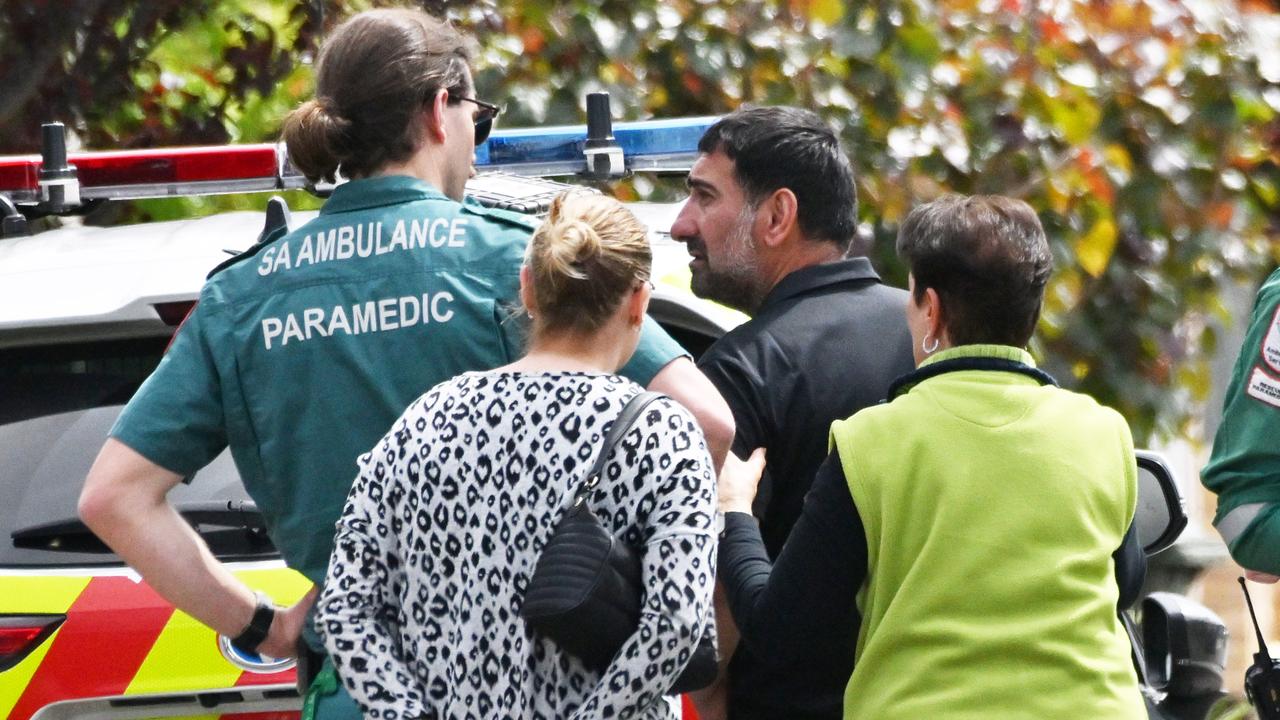 Family members with paramedics at the scene. Picture: Brenton Edwards