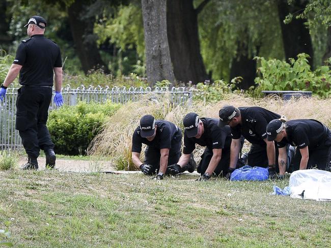 Police conduct fingertip searches of Queen Elizabeth Gardens, in Salisbury. Picture: AP