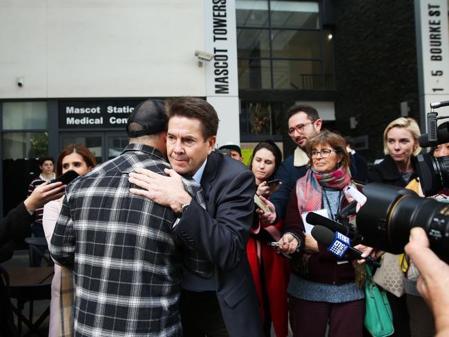 NSW Minister for better regulation, Kevin Anderson hugs Mascot resident Fabiano Dos Santos. Picture: Jane Dempster/The Australian.