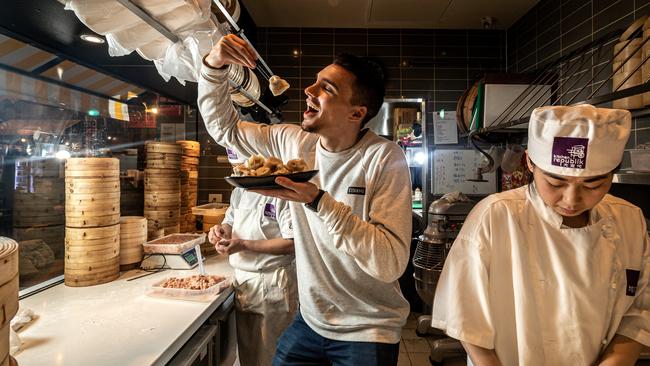 Restaurant customer Joel Spear trying some dumplings in Box Hill.